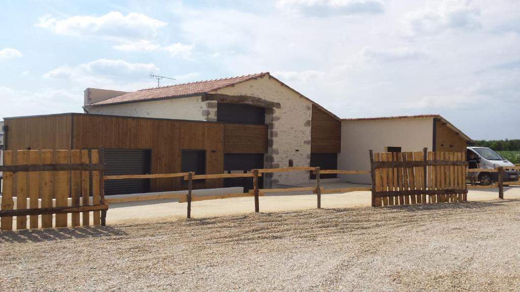 a building with a fence in front of it at La Ry'Bambelle in Les Herbiers