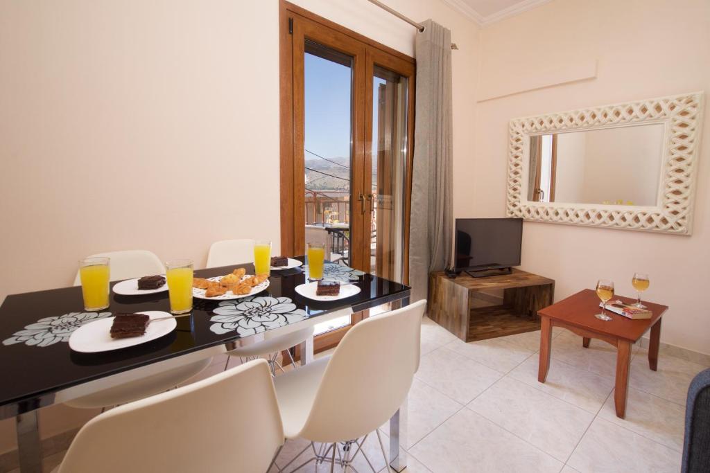 a kitchen and living room with a table and chairs at "Hermes" central apartment in Argostoli