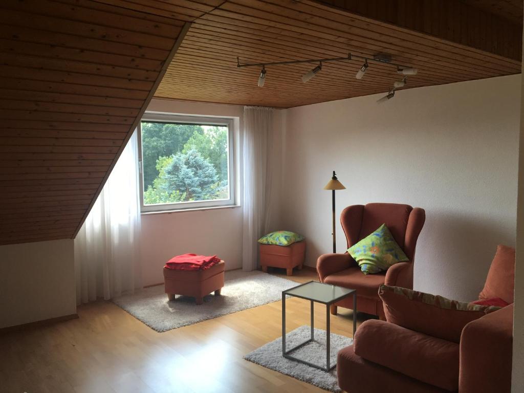 a living room with a couch and a window at Fair & the City in Düsseldorf