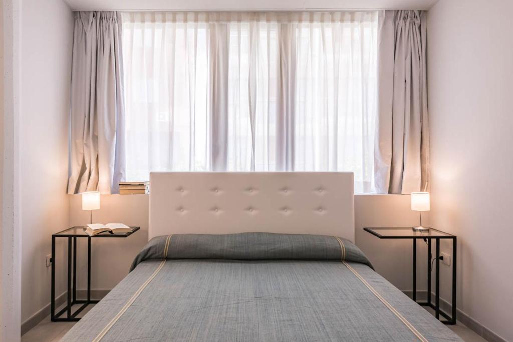 Łóżko lub łóżka w pokoju w obiekcie Le Residenze di Don Nino (Suites & Apartments)