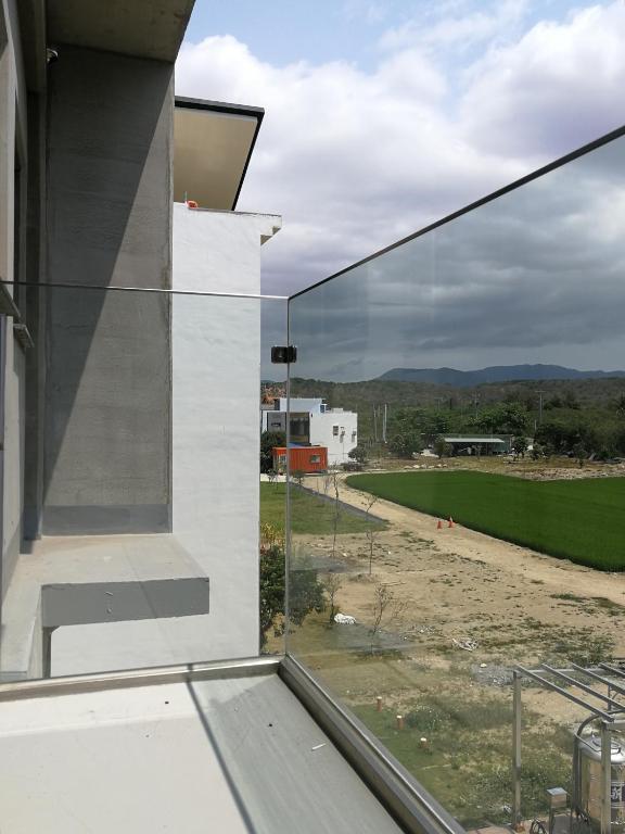 a glass window of a building with a view of a field at 墾丁 住在Zhuzai in Checheng