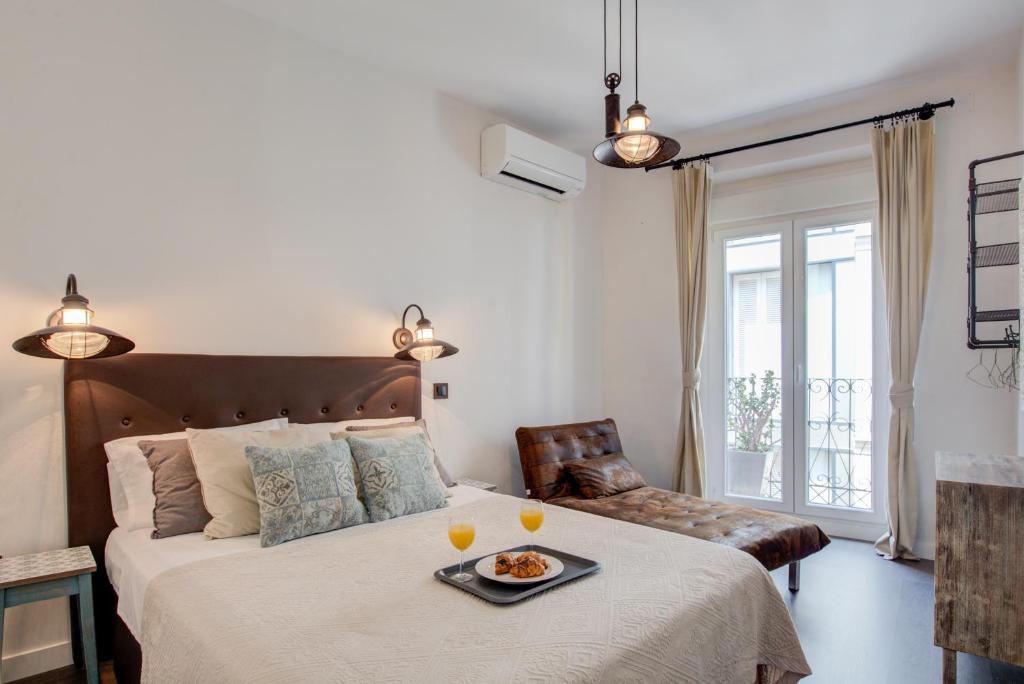 a bedroom with a bed with a tray of food on it at Fee4Me Marques Vintage Apartment in Madrid