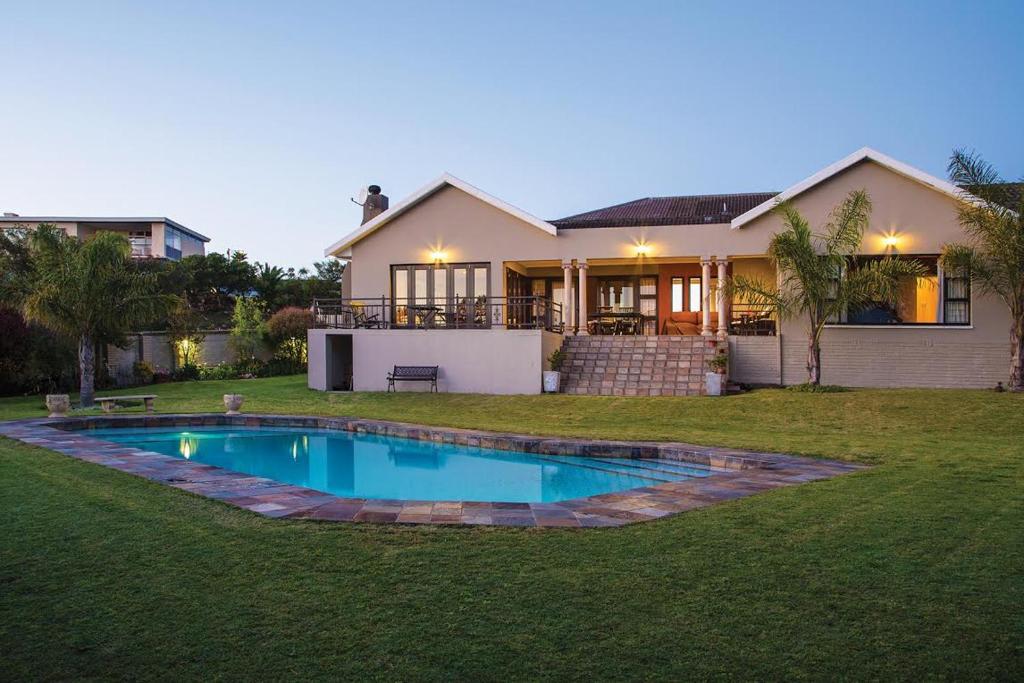 a house with a swimming pool in the yard at Lalapanzi Guest Lodge in Port Elizabeth