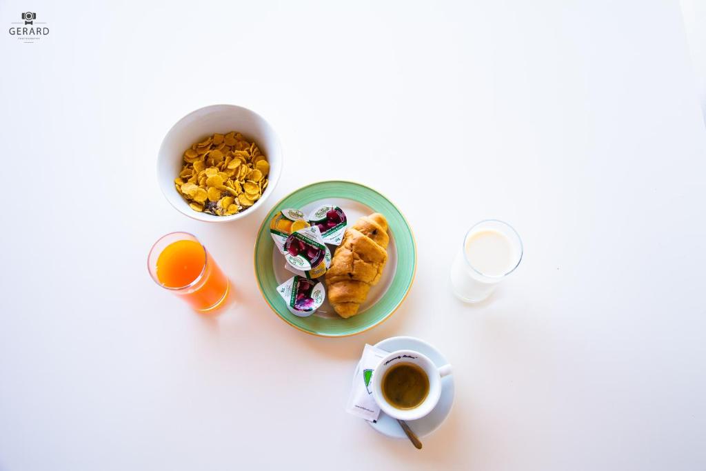 a table with a plate of food and a cup of coffee at Apartments Alavana in Velipojë