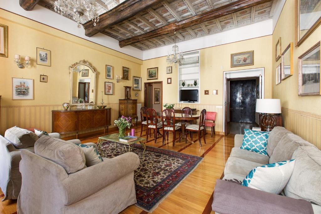 a living room with two couches and a dining room at ROMAC Villa Medici 3-Bedroom Holiday Apartment near Spanish Steps in Rome