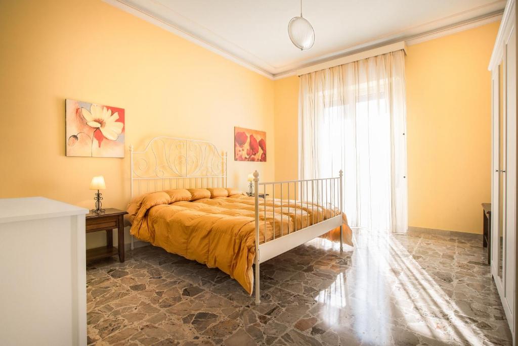 - une chambre avec un lit et une grande fenêtre dans l'établissement Casa Giolele, à Acireale