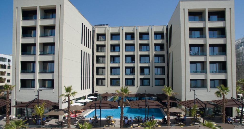 a hotel with a pool in front of a building at Royal G Hotel and Spa in Durrës