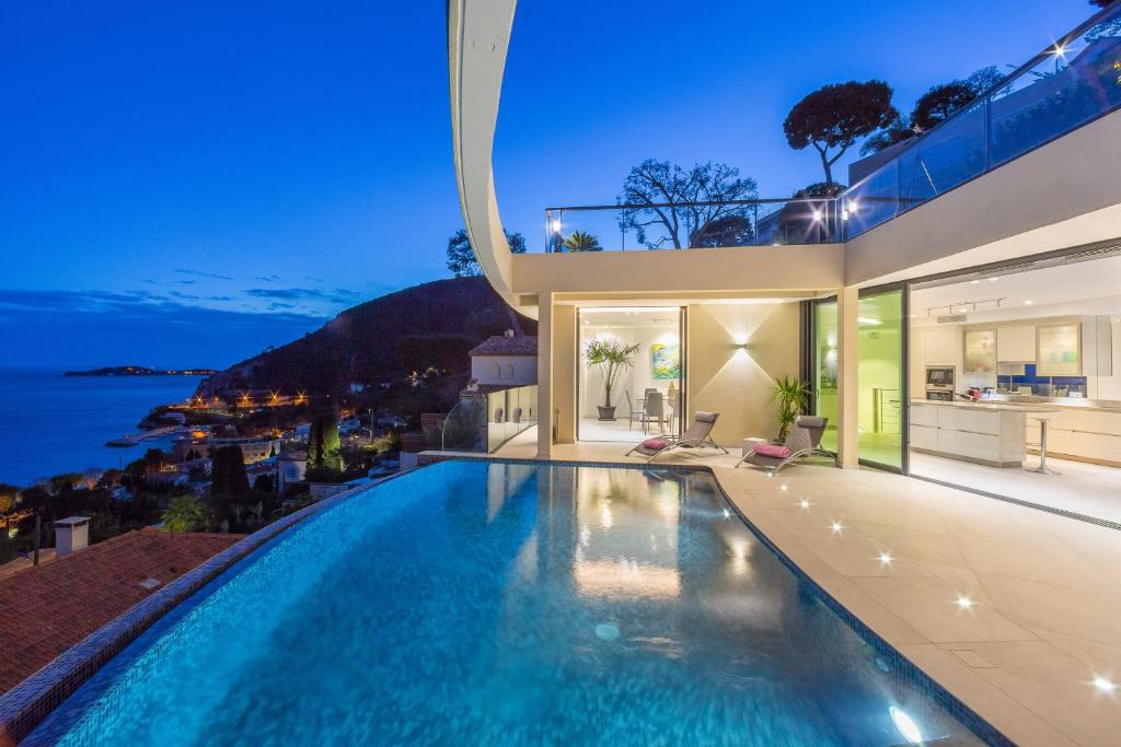 a swimming pool in a house with a view of the ocean at Villa Paradise in Éze