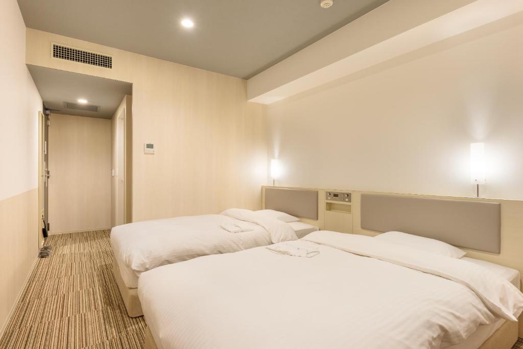 Postel nebo postele na pokoji v ubytování Belken Hotel Kanda