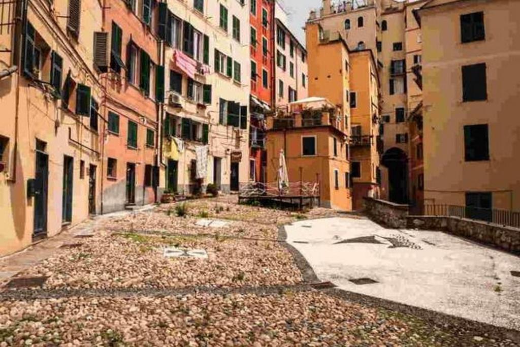 an empty alley in a city with buildings at H2.0 Genova in Genoa