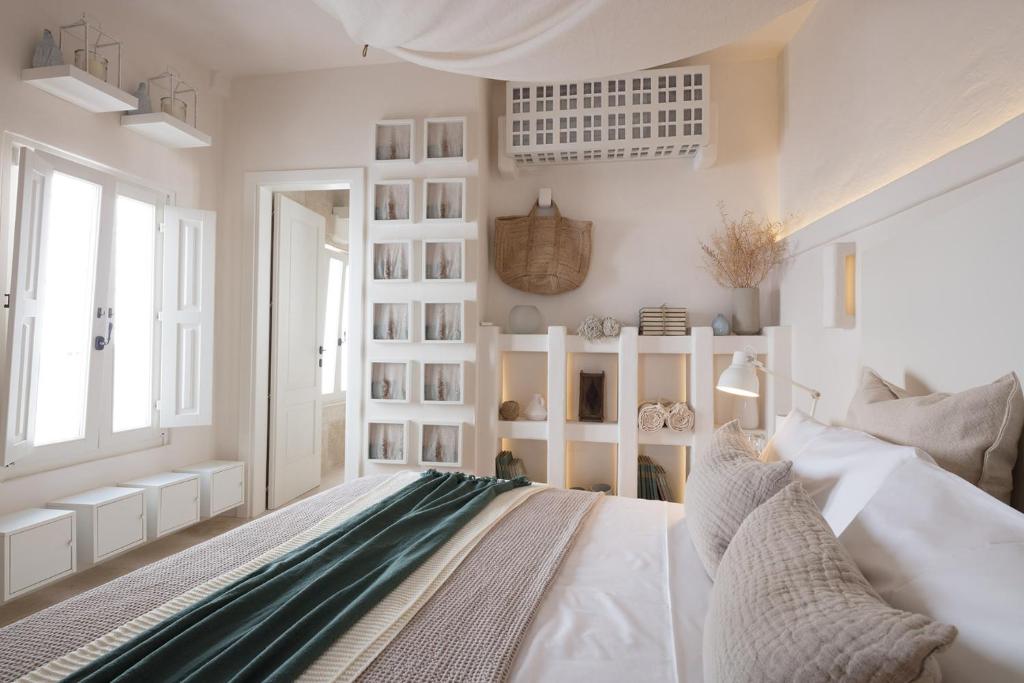 a bedroom with white walls and a large bed at Calumàre in Polignano a Mare