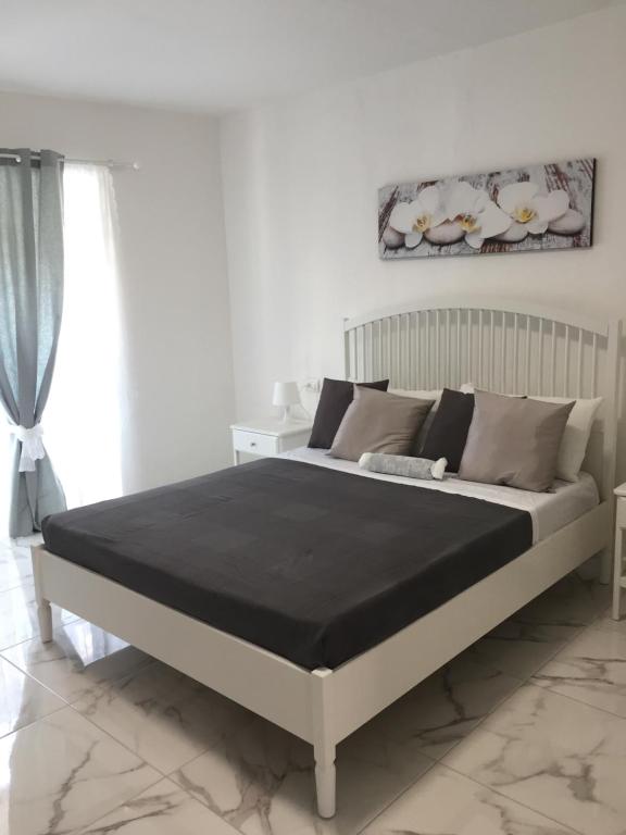 a bedroom with a large bed with a black blanket at CENTRALE in Orio al Serio