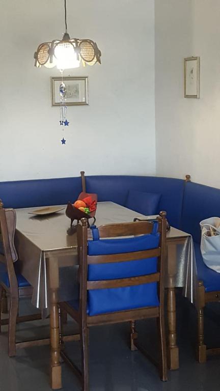 a dining room with a table and blue couch at appartamento Lory in Campomarino