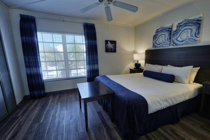 a bedroom with a large bed and a ceiling fan at GetAways at Dover House Resort in Delray Beach
