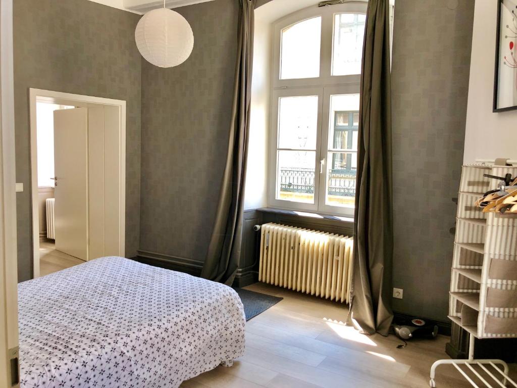 a bedroom with a bed and a window at Urban apartment, in the nightlife area! in Luxembourg