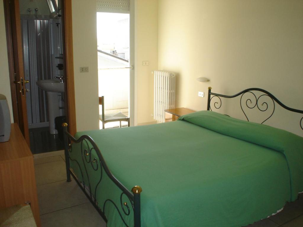 Postel nebo postele na pokoji v ubytování Hotel Esperia