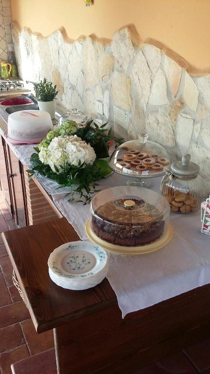 a table with a cake and other foods on it at Casale Del Borgo in Hermada