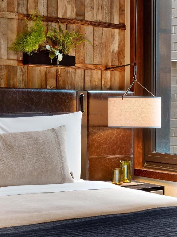 a bedroom with a bed and a lamp at 1 Hotel Central Park in New York