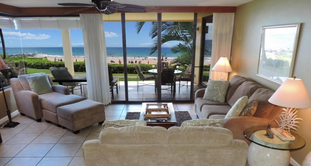 a living room with a couch and a view of the beach at Polo Beach Club in Wailea
