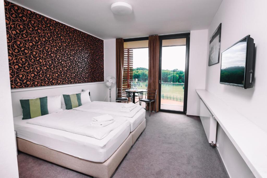 Postel nebo postele na pokoji v ubytování K-Triumf Resort