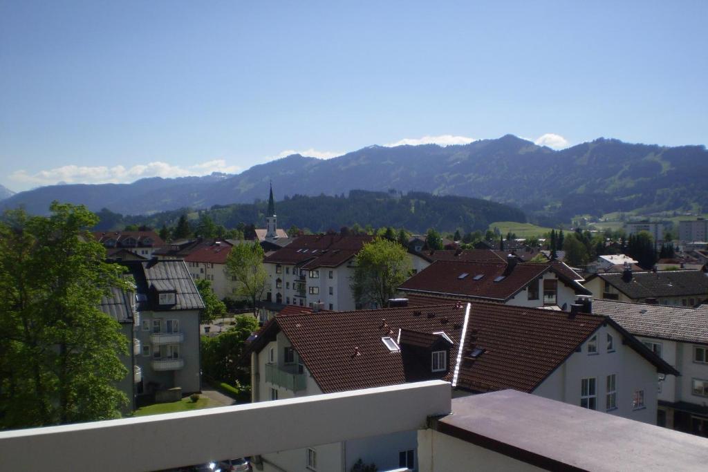 a city with houses and mountains in the background at PenthouseApartment 250° in Sonthofen
