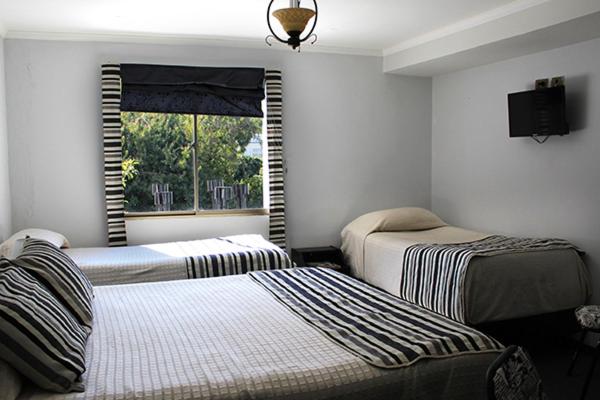 Postel nebo postele na pokoji v ubytování Hotel Maquehue