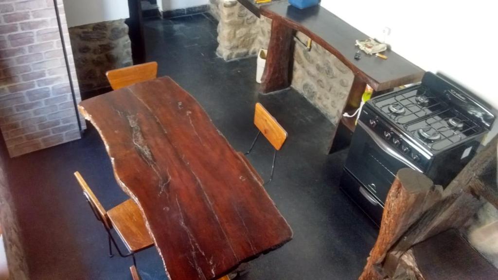 una mesa de madera y una estufa en una habitación en Casa El Mortero en Cafayate