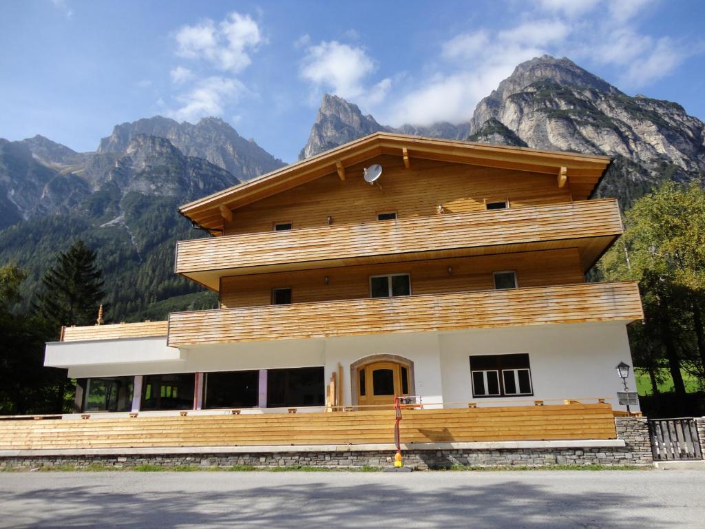 a house with mountains in the background at Gschnitzerhof in Gschnitz