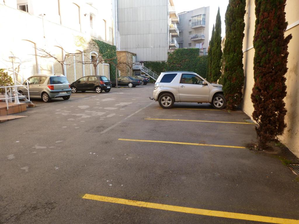 a car parked in a parking lot next to buildings at Hotel Costa Brava in Blanes