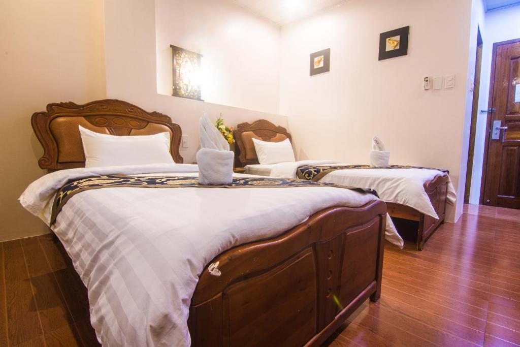 Postel nebo postele na pokoji v ubytování A&A Plaza Hotel