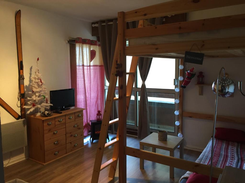a bedroom with a bunk bed and a christmas tree at studio saint lary soulan in Saint-Lary-Soulan