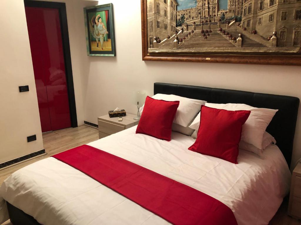 a bedroom with a large bed with red pillows at Roma Papalina in Rome