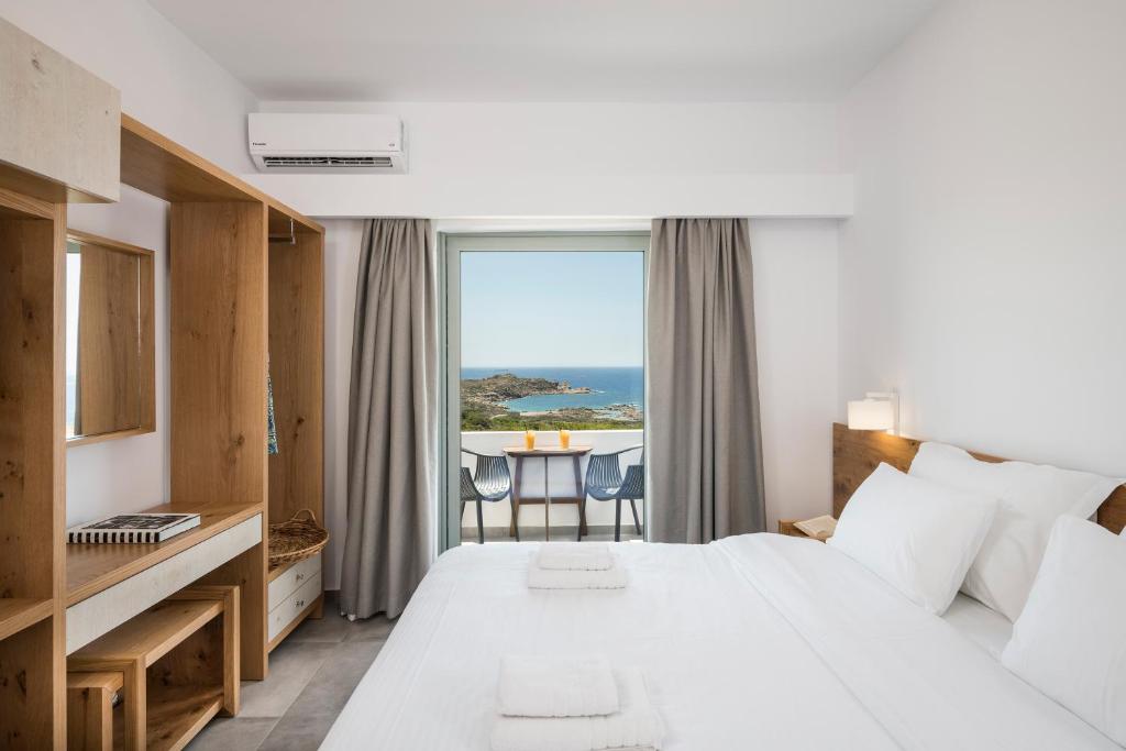 a hotel room with a bed and a window at Glykeria Hotel in Elafonisi