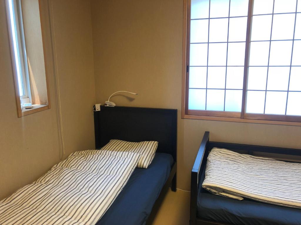 Postel nebo postele na pokoji v ubytování Tokyo Art House
