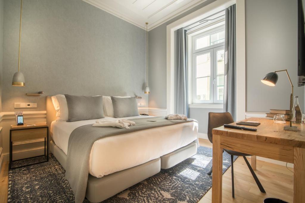 Postel nebo postele na pokoji v ubytování Hotel da Baixa