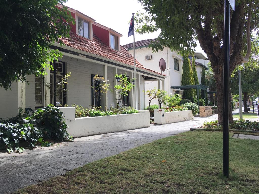 a building with a flag on the side of it at Charming Federation style home minutes from CBD in Perth