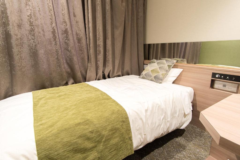 Postel nebo postele na pokoji v ubytování Fujinomiya Fujikyu Hotel