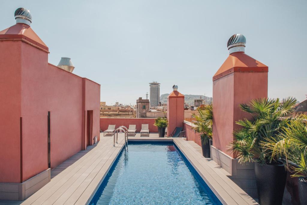 a swimming pool on the roof of a building at Aparthotel Arai 4* Superior in Barcelona