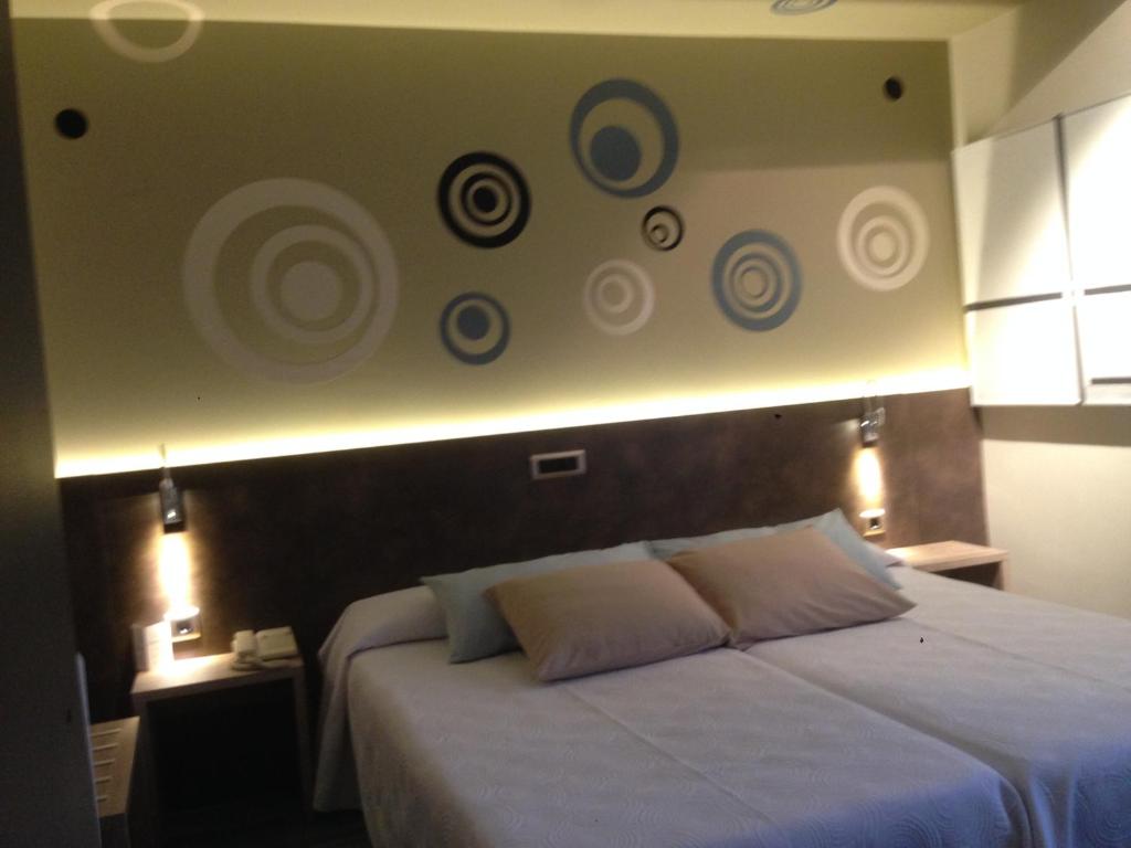 Postel nebo postele na pokoji v ubytování Hotel Oriente