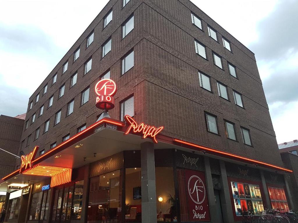 a building with a sign on the front of it at Apartments Centralstation in Uppsala