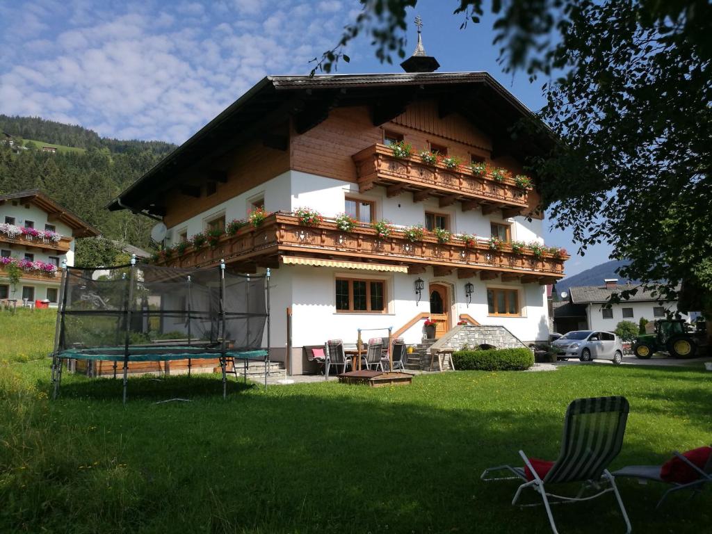 a house with a balcony on top of it at Schartlhof in Flachau