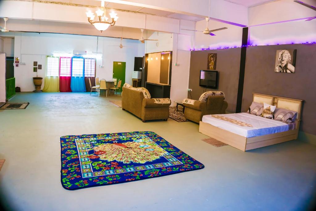 a bedroom with a bed and a rug on the floor at Ipoh Boutique Stay in Ipoh