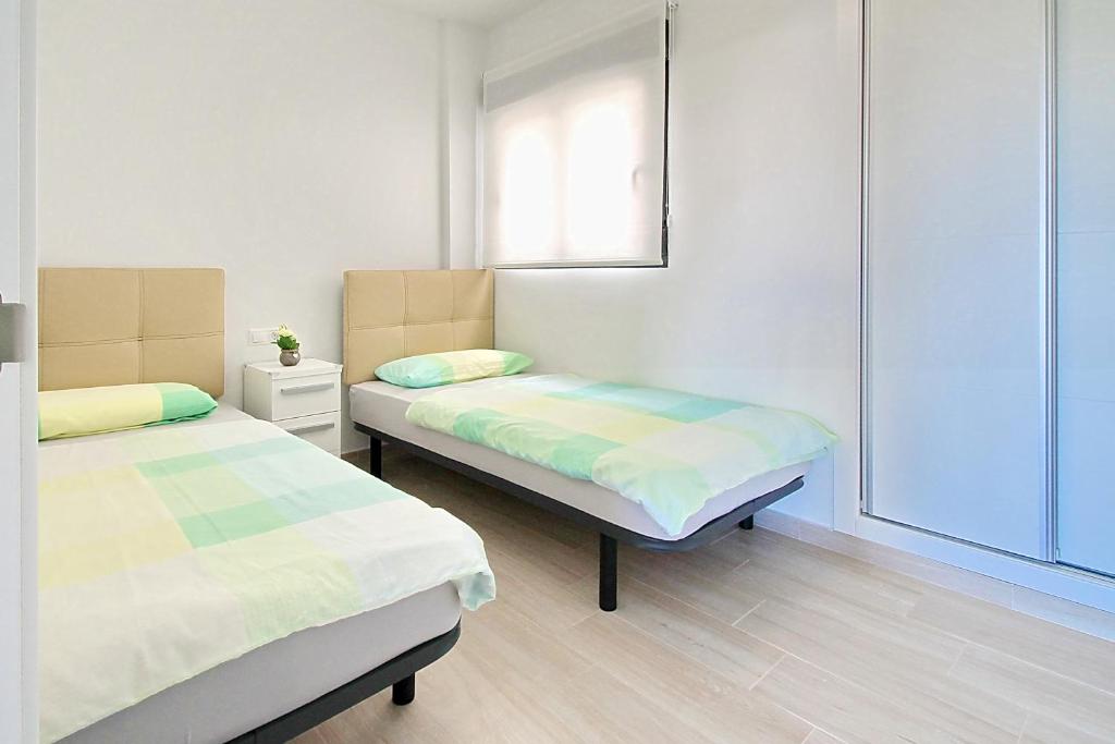A bed or beds in a room at Alex Sun