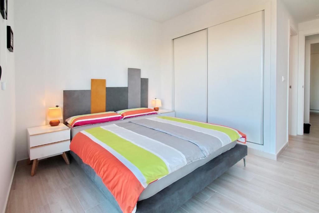 A bed or beds in a room at Alex Sun