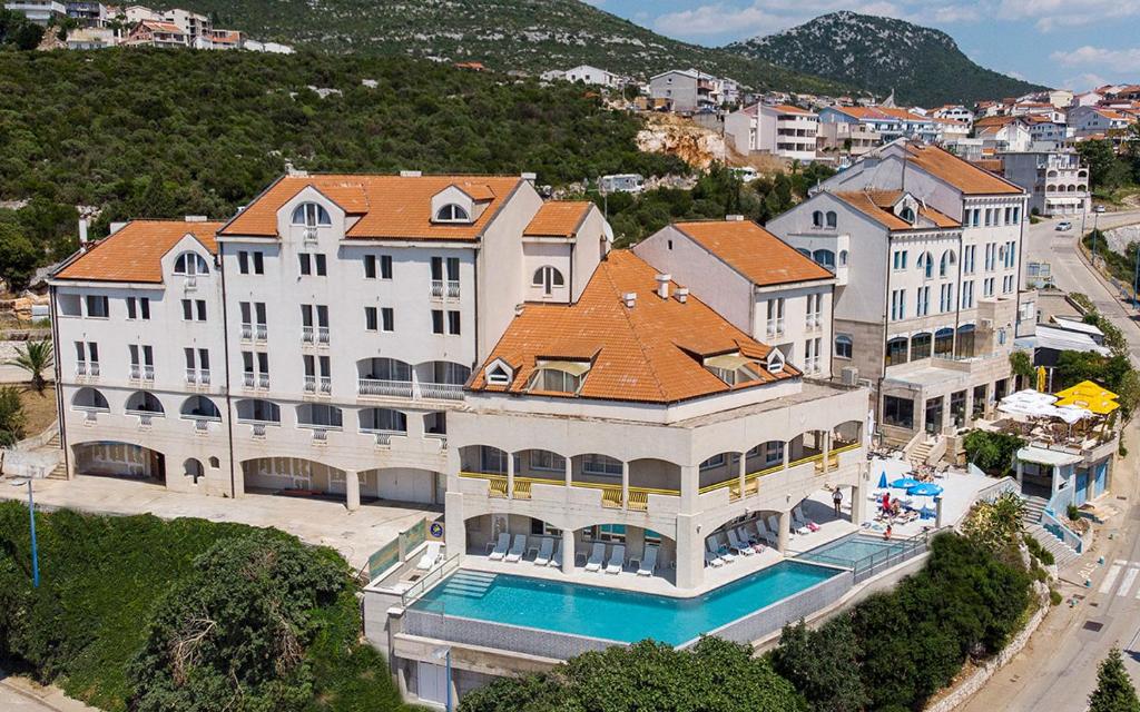 an aerial view of a large white building with a pool at Hotel Stella in Neum