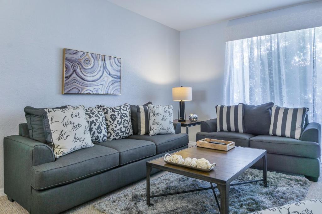 a living room with a couch and a table at Tideview Circle Unit 57 Condo in Orlando