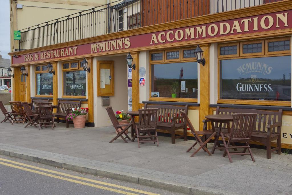 a row of tables and chairs outside of a restaurant at McMunns of Ballybunion in Ballybunion