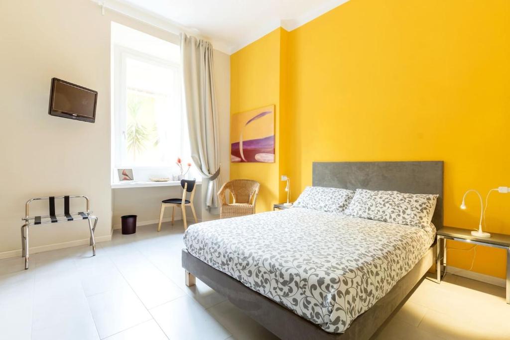 ローマにあるPaola Guest Houseの黄色の壁のベッドルーム1室