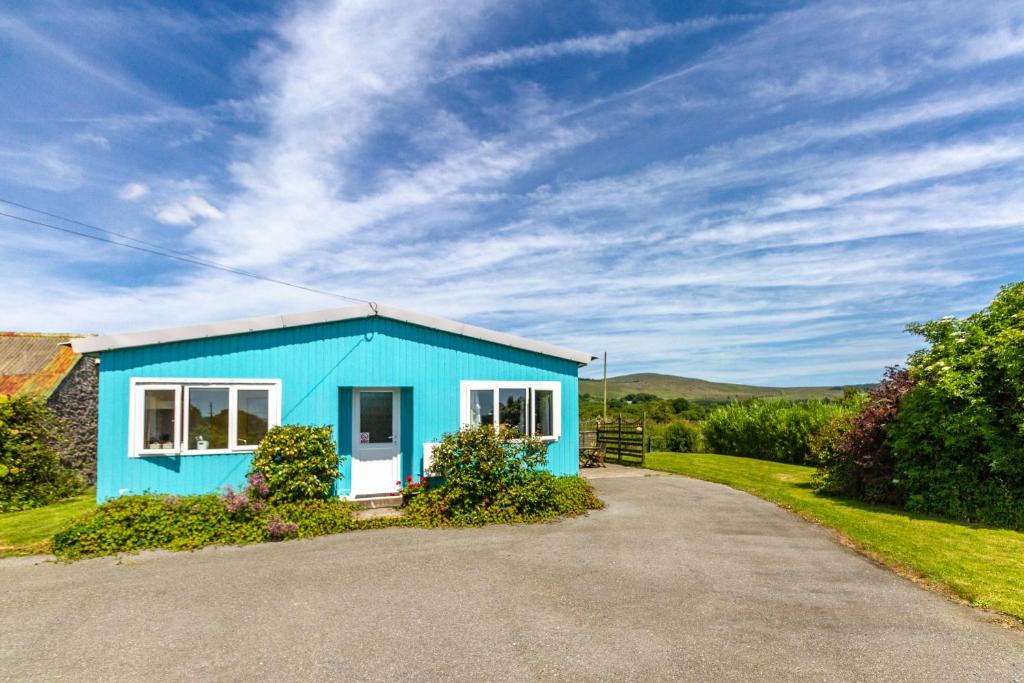 a blue house on the side of a road at Ty Pren Bach in Maenclochog