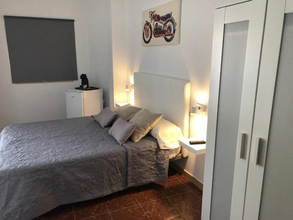 Кровать или кровати в номере Hostal Tamonante